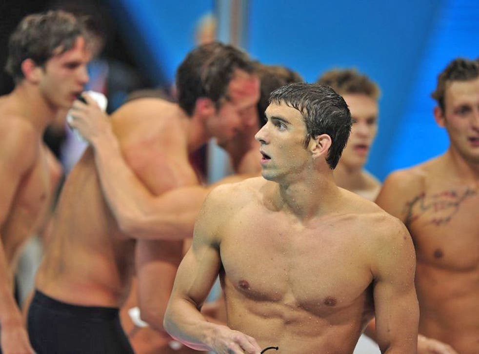 Michael Phelps can hardly believe it as the French celebrate
