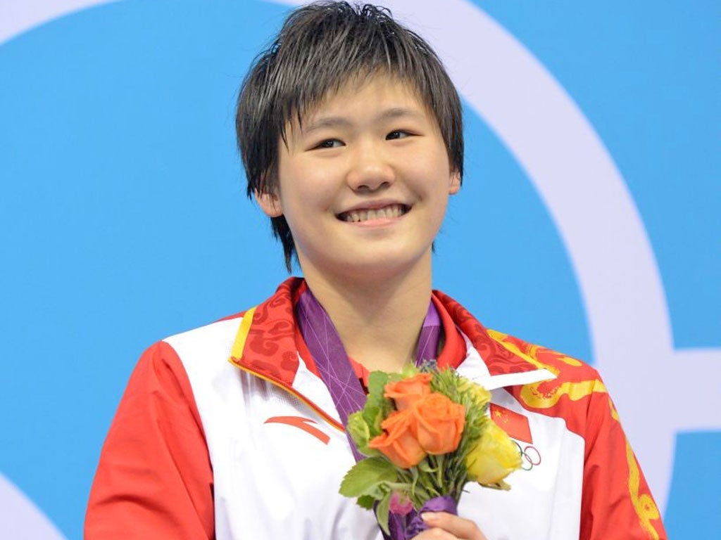 China's Ye Shiwen celebrates on the podium of the women's 400m individual medley final swimming event
