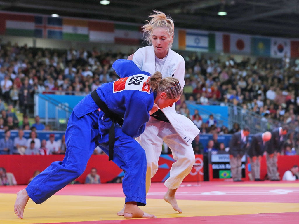 July 30, 2012: France's Automne Pavia fights with Team GB's Sarah Clark (blue) during their women's -57kg elimination round of 32 judo match