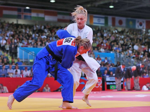 July 30, 2012: France's Automne Pavia fights with Team GB's Sarah Clark (blue) during their women's -57kg elimination round of 32 judo match