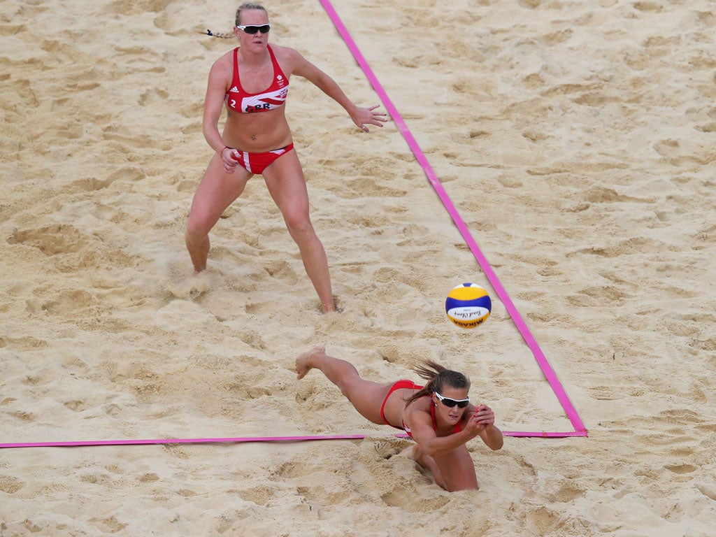 Zara Dampney of Great Britain dives for a shot during the Women's Beach Volleyball Preliminary match between Great Britain and Italy