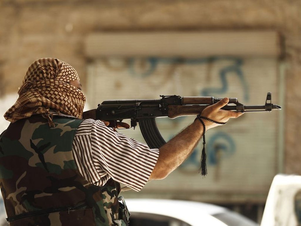 A member of the Free Syrian Army aims his weapon in Aleppo's district of Salah Edinne