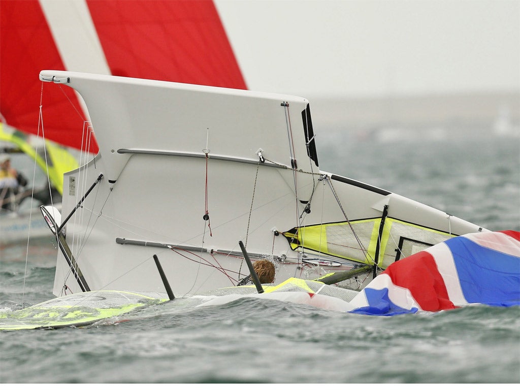 Great Britain’s 49er class crew Stevie Morrison and Ben Rhodes capsize in Weymouth Bay yesterday