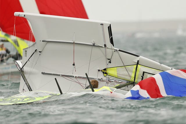 Great Britain’s 49er class crew Stevie Morrison and Ben Rhodes capsize in Weymouth Bay yesterday