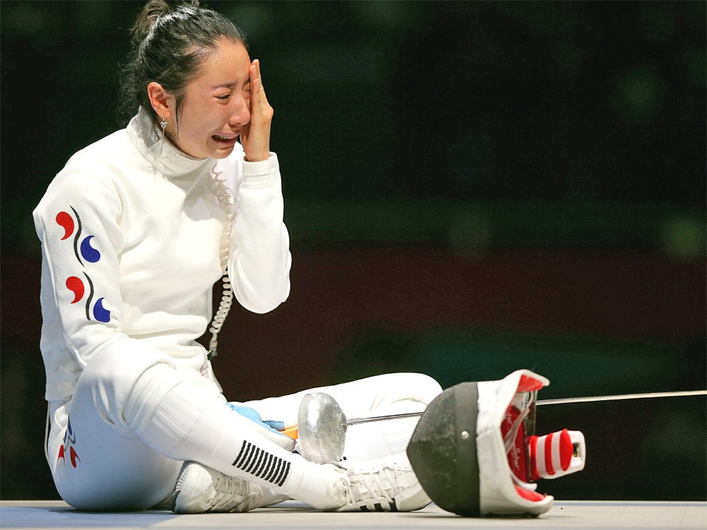 South Korean fencer Shin Lam refused to leave the piste when she lost to a German opponent after a controversial last-second blow in the epee semi-finals