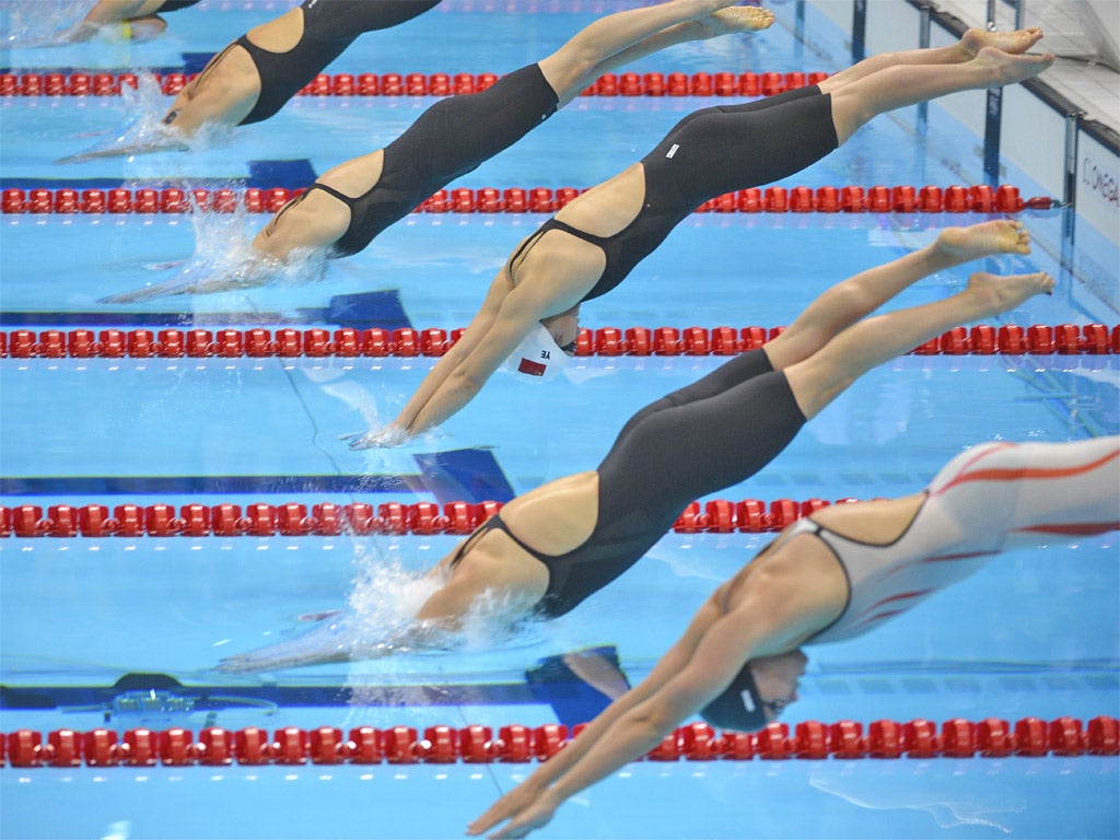 Ye Shiwen (centre) dives at the start of the 200m IM final last night