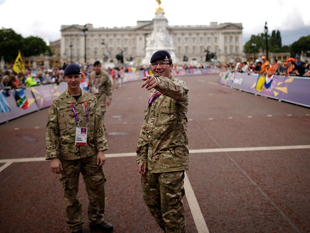 Soldiers man security fences outside Buckingham Palace on the Mall on Sunday