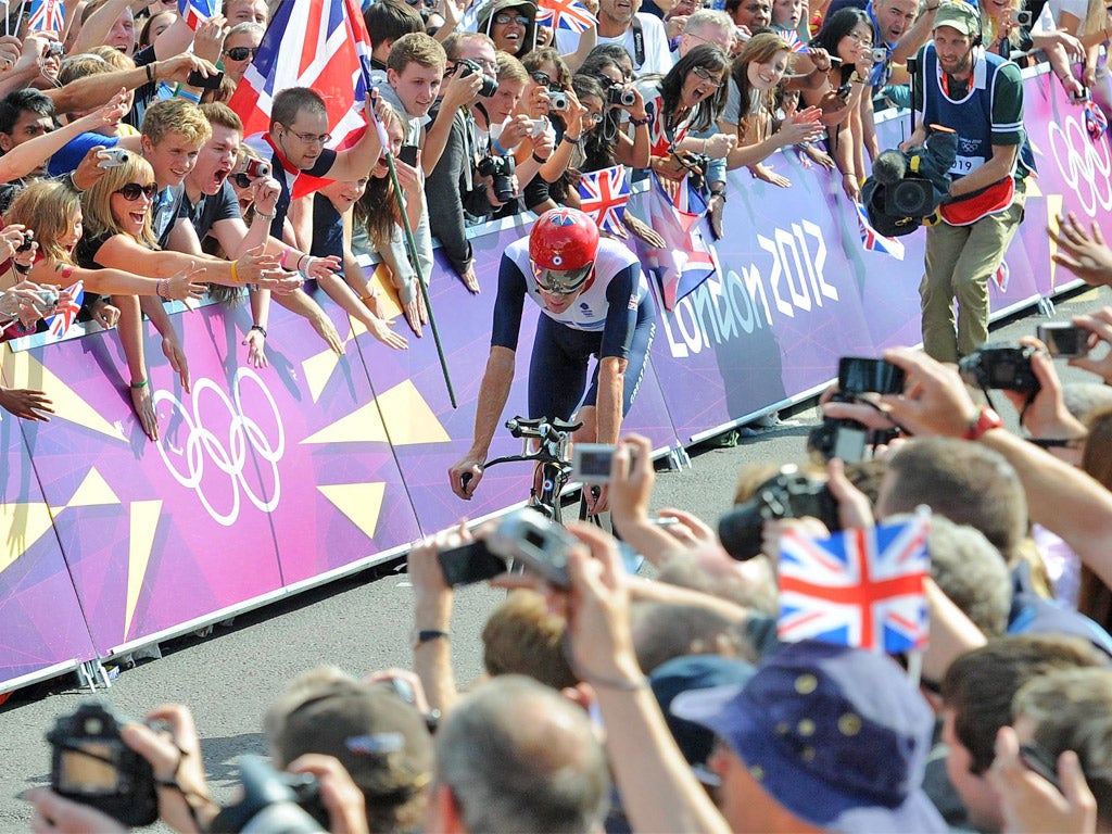 Bradley Wiggins is cheered on by an adoring public as he wins the time trial