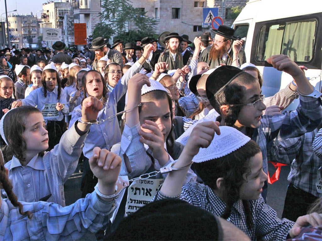 Handcuffed ultra-orthodox Jewish children march in Jerusalem in protest over army recruitment