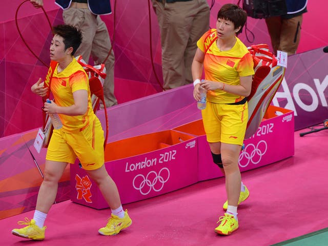 Yu Yang (left) and her partner Wang Xiaoli leave the court after their Women's Doubles Badminton match against South Korea