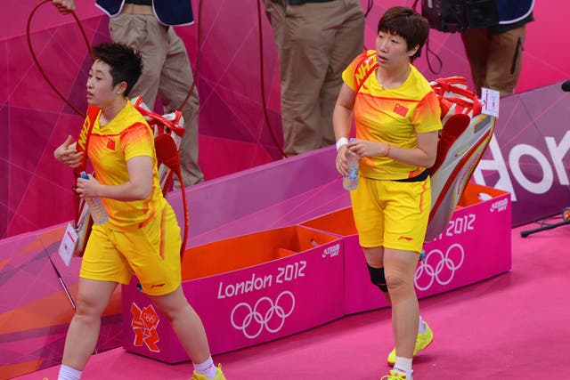 Yu Yang (left) and her partner Wang Xiaoli leave the court after their Women's Doubles Badminton match against South Korea