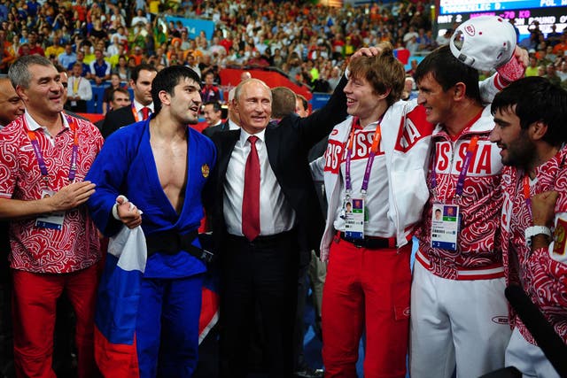 President Vladimir Putin celebrates Tagir Khaibulaev's gold medal in the Men’s under-100kg judo competition
