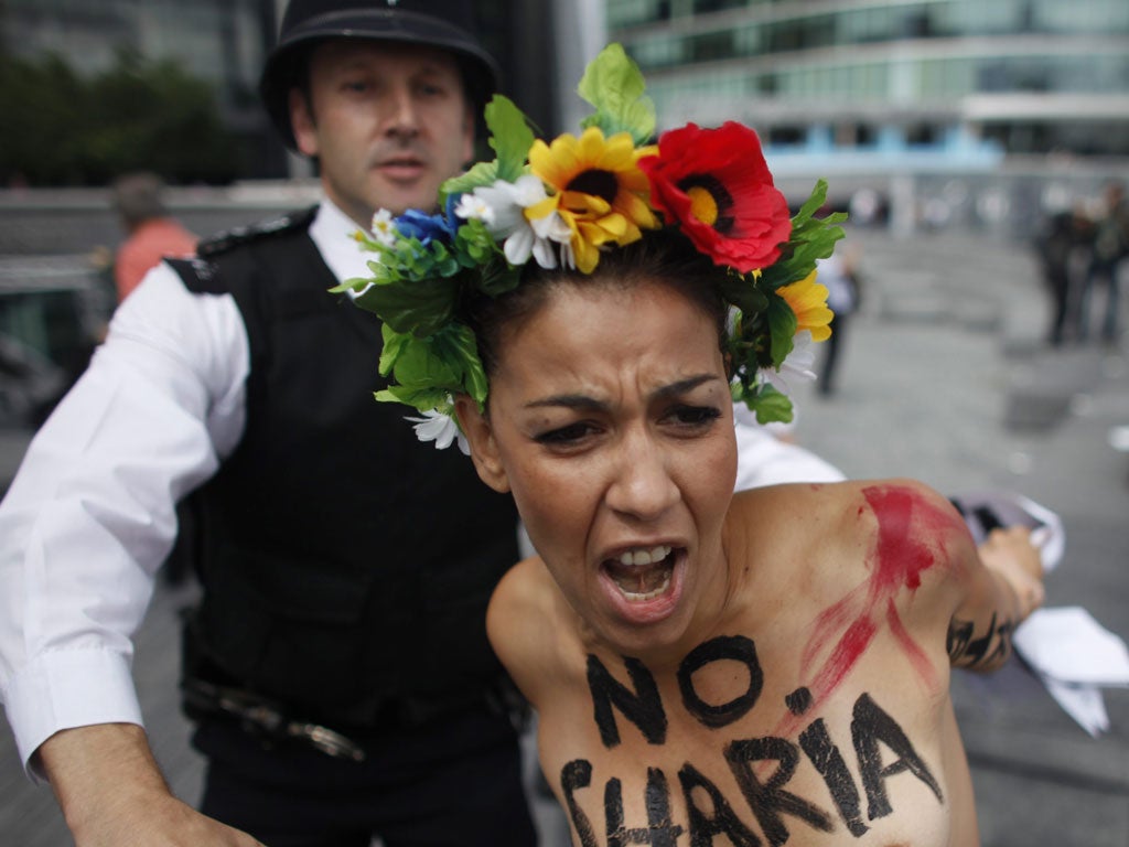 A protester from Ukranian group FEMEN is arrested