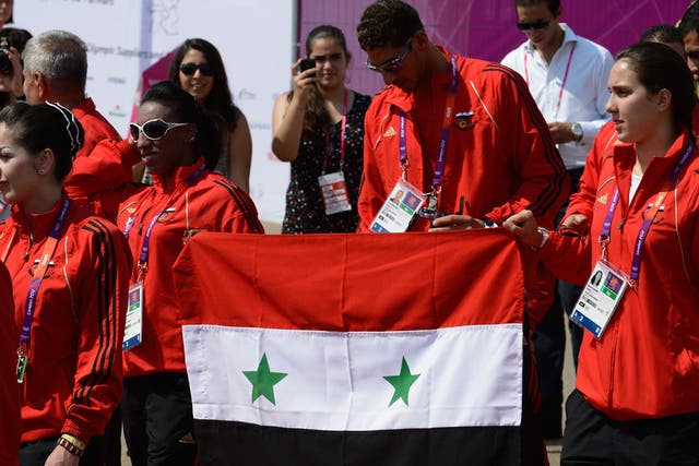 Syrian athletes carry their national flag