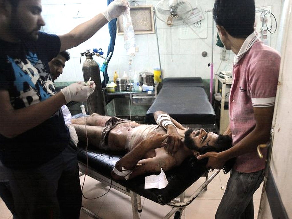 Medics defy the regime and treat a wounded Syrian rebel in a hospital near Aleppo