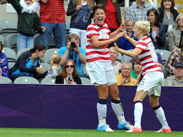 Abby Wambach (left) celebrates after scoring the first American goal