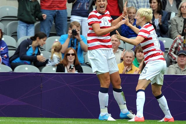Abby Wambach (left) celebrates after scoring the first American goal