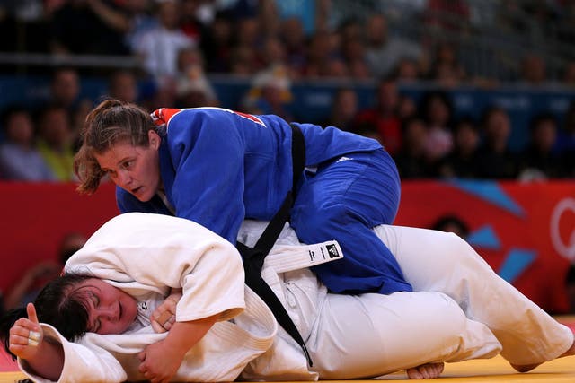 Karina Bryant (top) tussles with Iryna Kindzerska in their bronze medal match