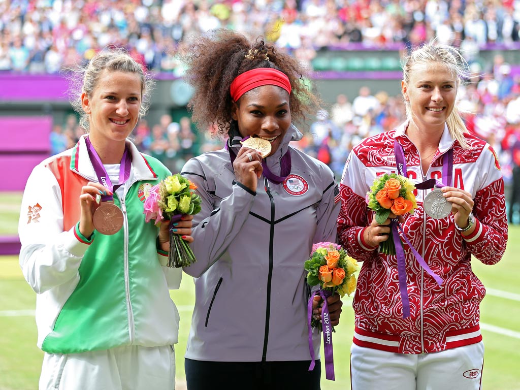 August 4, 2012: Silver medalist Maria Sharapova (right) of Russia, gold medalist Serena Williams (centre) of the United States and bronze medalist Victoria Azarenka (left) of Belarus receive their medals at Wimbledon