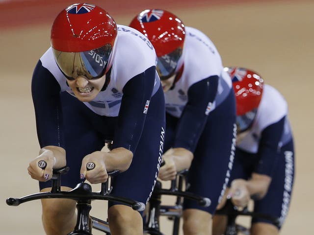 Grin to win: Great Britain women's pursuit team during another world record ride on the track yesterday