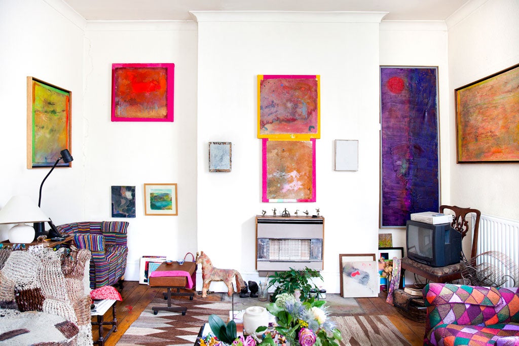 A life illuminated: The living-room boasts several paintings by Bowling and African figurines inherited from Scott's mother, which sit above the fireplace. The chairs and covers were made by Scott