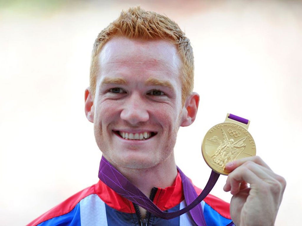 Greg Rutherford shows off his medal at yesterday’s presentation
ceremony