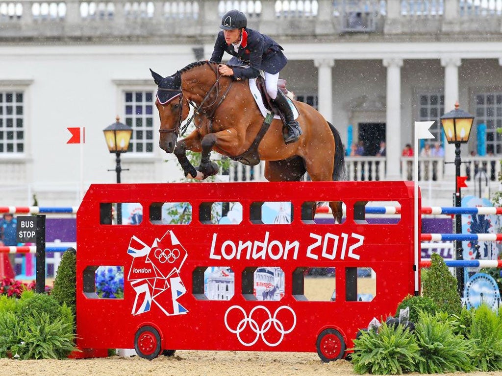 Picture of the day: Great Britain’s Scott Brash rides Hello Sanctos over a furlong depicted as a London bus in yesterday’s second qualifier of the individual jumping at Greenwich Park