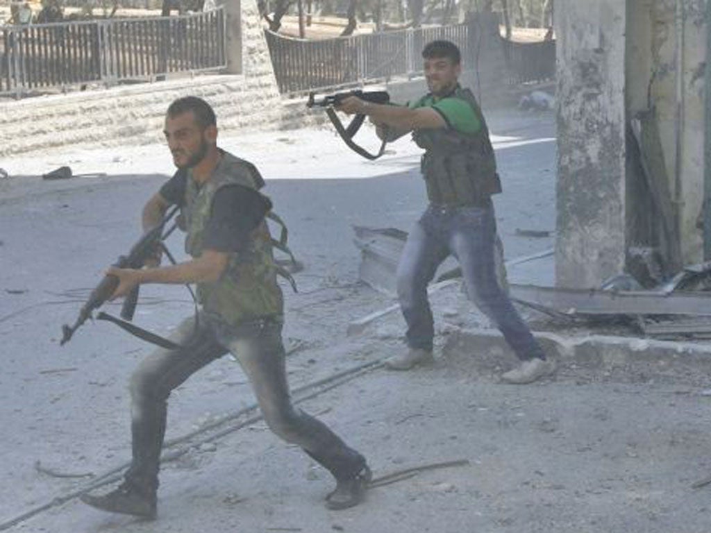 Free Syrian Army fighters clash with regime troops in the Salah al-Din neighbourhood of central Aleppo yesterday