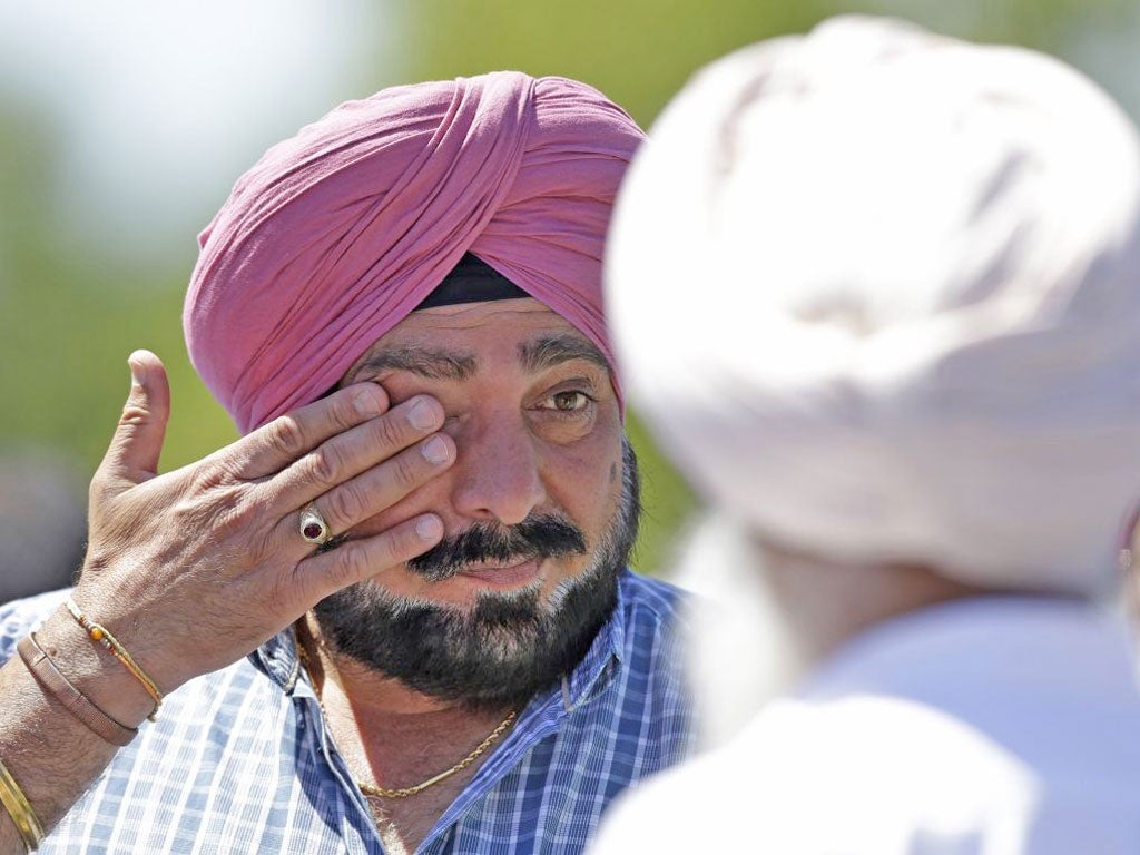 &#13;
A man wipes away tears outside the Sikh Temple in Oak Creek, Wisconsin, where seven people were killed in 2012&#13;