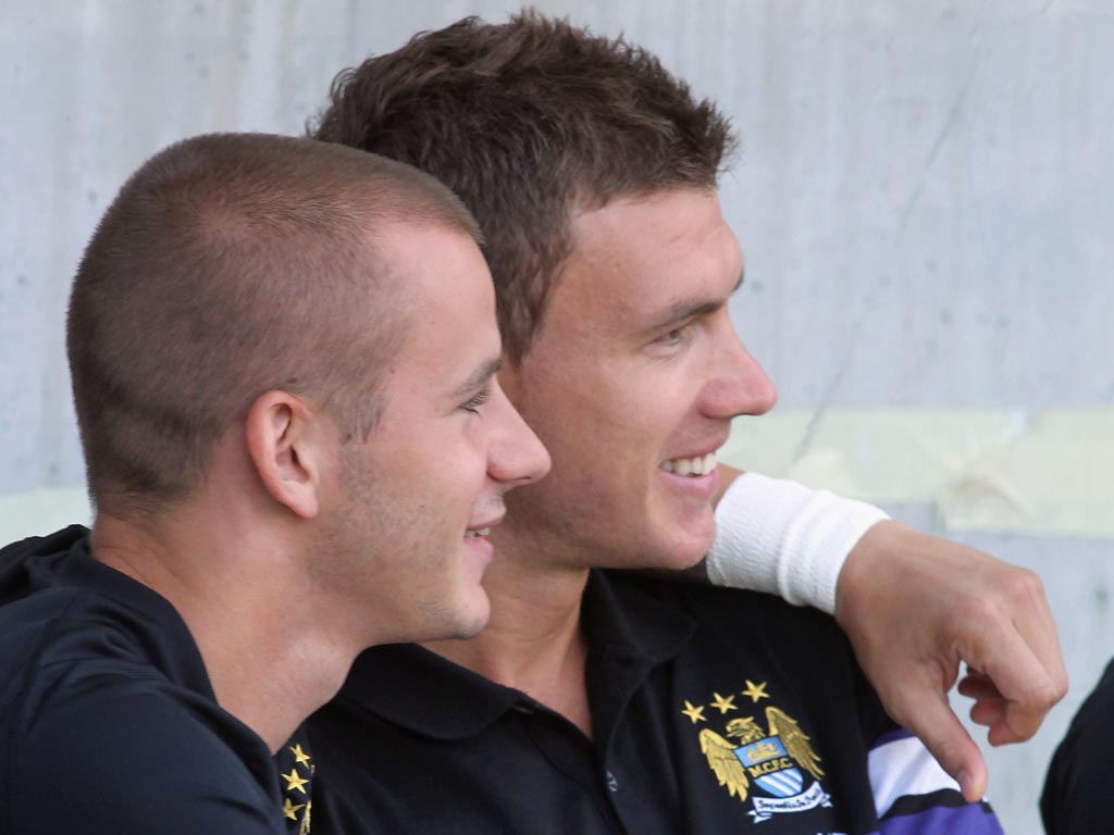 Vladimir Weiss (left) of Manchester City hugs team mate Edin Dzeko during pre-season
