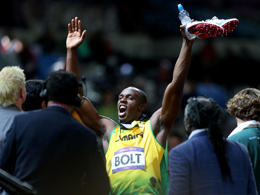 Usain Bolt celebrates his 100 metres victory