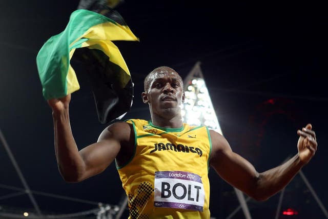 Usain Bolt celebrates his 100 metres victory