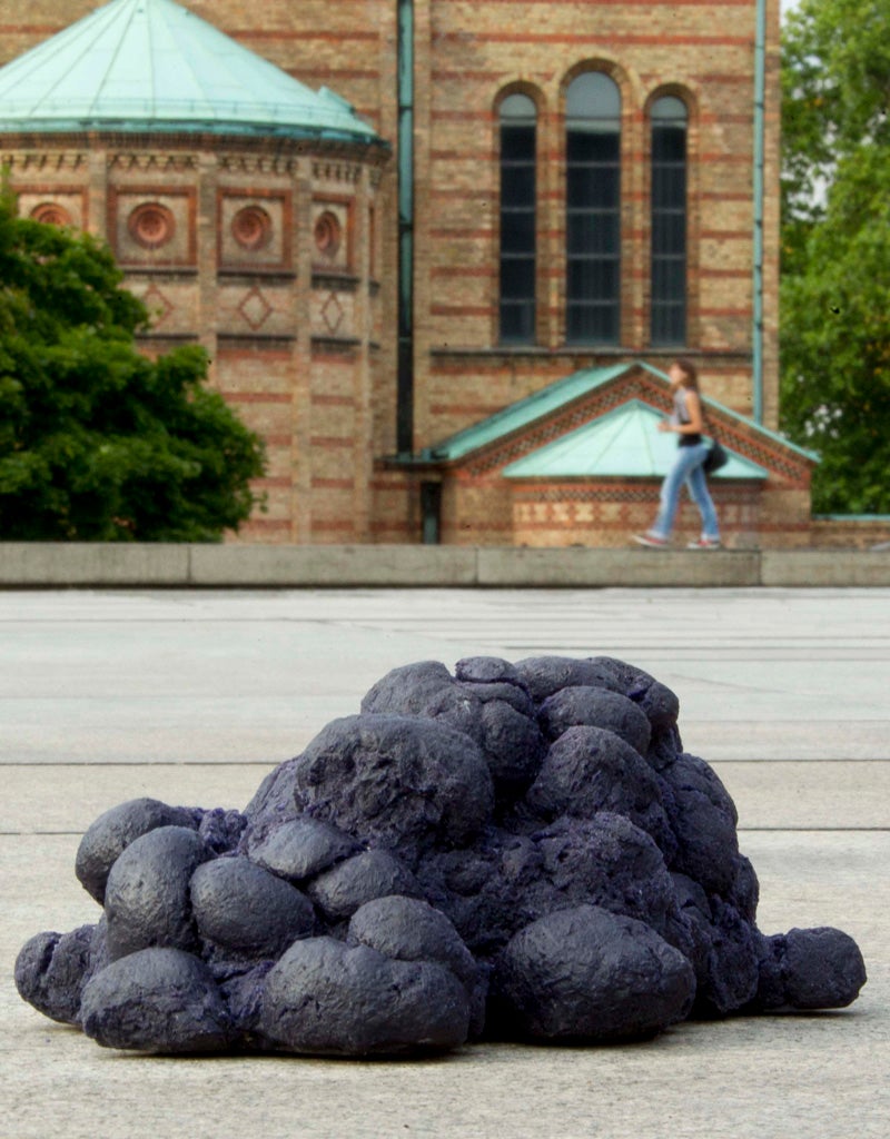 A pile of artificial dung sits in front of the New National Gallery in Berlin