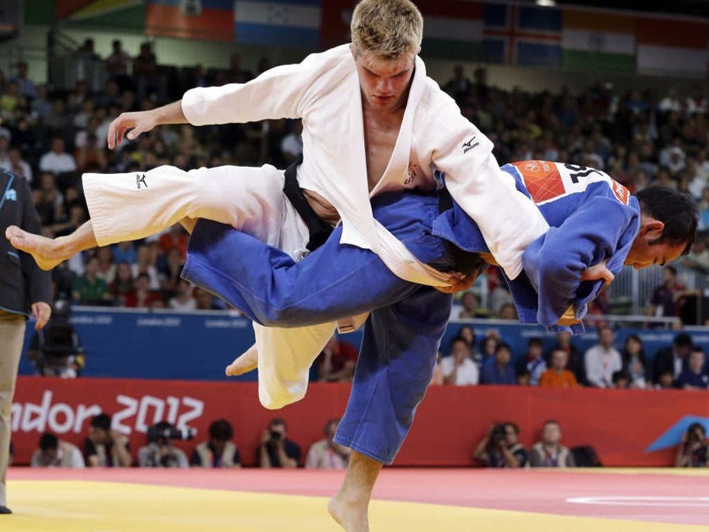 30 July 2012: Nicholas Delpopolo of the United States, in white, and Nyam Ochir Sainjargal of Mongolia compete during the men's 73-kg judo competition