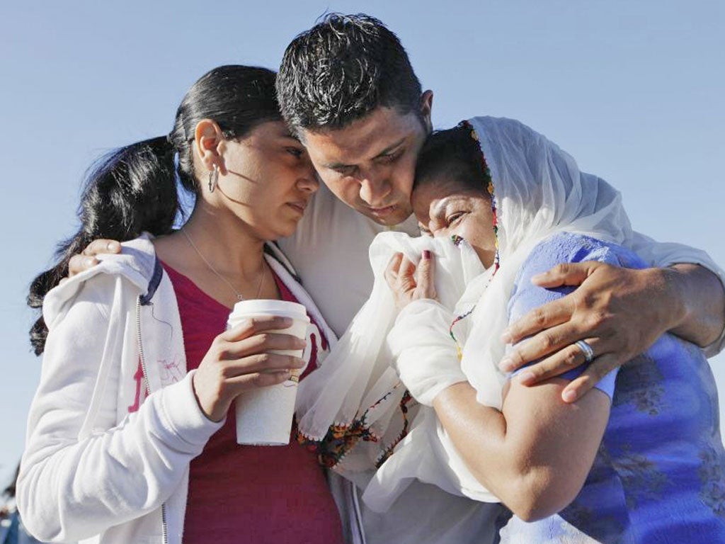 Amardeep Kaleka comforts members of the temple in Oak Creek yesterday