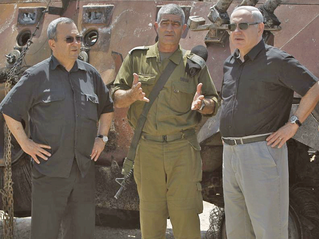 Prime Minister Benjamin Netanyahu, right, with Defence Minister Ehud Barak, left, and military commander Tal Russo, at the attack site