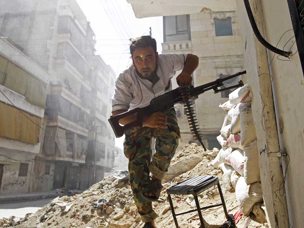 A Free Syrian Army fighter takes cover during clashes in Aleppo