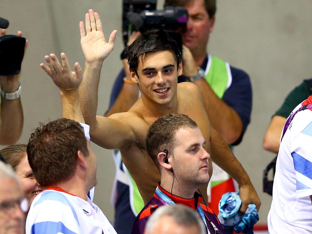 August 7, 2012: Chris Mears of Great Britain high fives a member of the Great Britain team after reacing the Men's 3m Springboard final in which he finished ninth