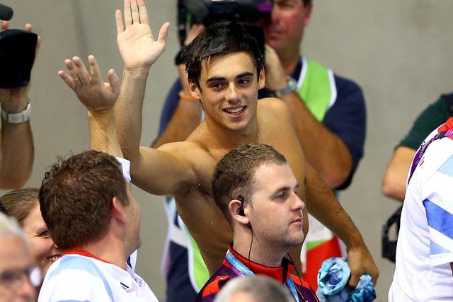 August 7, 2012: Chris Mears of Great Britain high fives a member of the Great Britain team after reacing the Men's 3m Springboard final in which he finished ninth