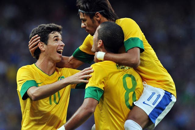August 7, 2012: Oscar (left) and Neymar (right) congratulate the opening goalscorer of Brazil's semi-final against South Korea, Romulo 
