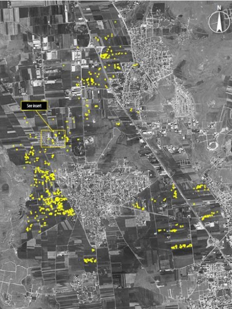This satellite image shows what Amnesty International believes are 600 probable artillery impact craters from heavy fighting between Syrian armed forces and armed opposition groups in the village of Anadan