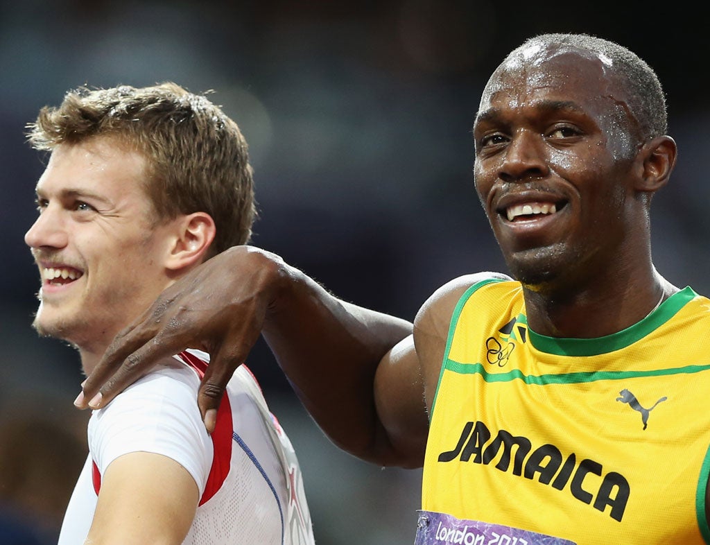 August 8, 2012: Usain Bolt of Jamaica puts his arm on the shoulder of Christophe Lemaitre of France after his men's 200m semifinals