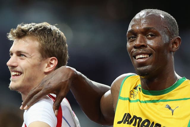 August 8, 2012: Usain Bolt of Jamaica puts his arm on the shoulder of Christophe Lemaitre of France after his men's 200m semifinals