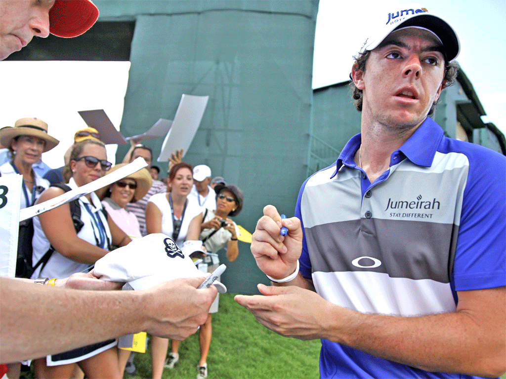 Rory McIlroy signs autographs at a saturated Ocean Course
