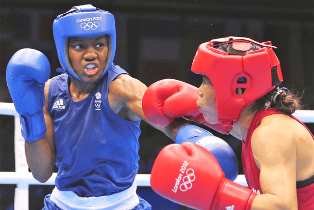 Nicola Adams (left) overpowers Mary Kom in their semi-final