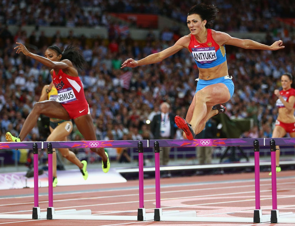 August 2, 2012: Natalya Antyukh of Russia crosses the finish line ahead of Lashinda Demus of the United States in the Women's 400m Hurdles Final