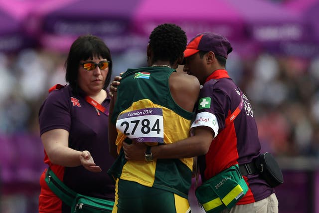 August 9, 2012: Ofentse Mogawane of South Africa receives assitance after crashing out of the men's 4 x 400 metres relay