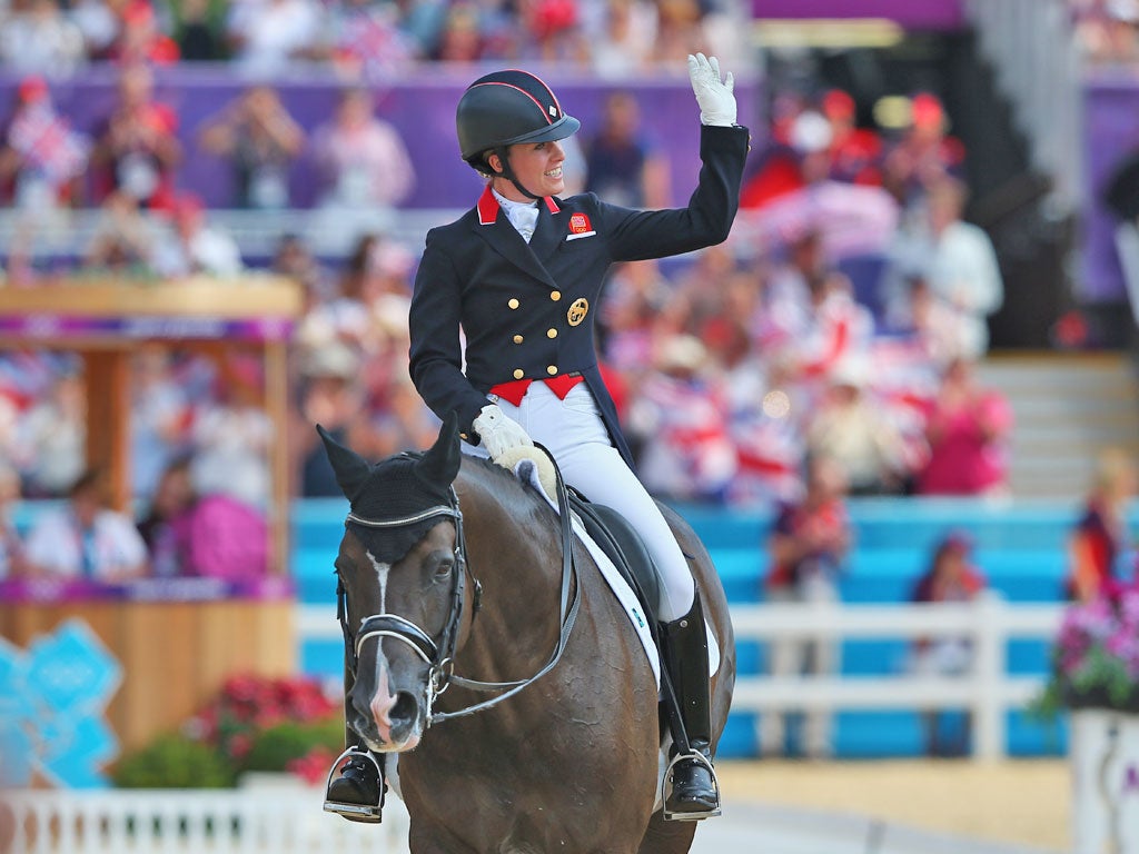 August 9, 2012: Charlotte Dujardin celebrates winning gold in as individual freestyle champion