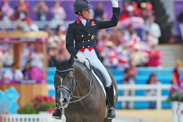 August 9, 2012: Charlotte Dujardin celebrates winning gold in as individual freestyle champion