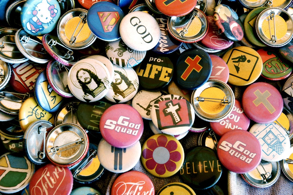 Badge of office: religious buttons on sale at a Christian music festival